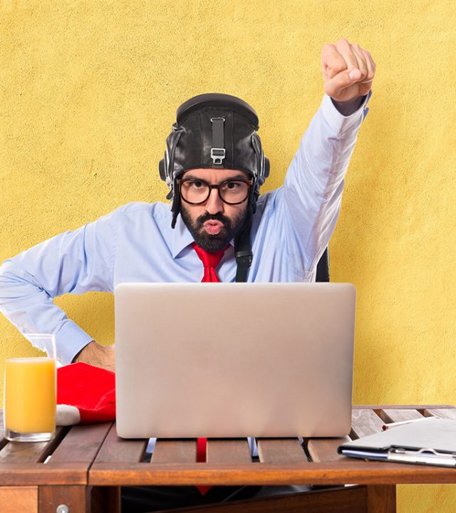 businessman in his office with pilot hat